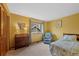 Cozy bedroom with natural light, a desk, and a comfortable chair at 18 Blue Sage, Littleton, CO 80127