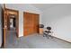 Carpeted room with open door, closet, and desk with computer and chair at 18 Blue Sage, Littleton, CO 80127