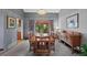 Elegant dining room with wood table, traditional accents, and view to the backyard at 18 Blue Sage, Littleton, CO 80127