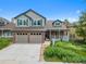 Charming home featuring a brick facade, a two-car garage, and a cozy front porch at 18 Blue Sage, Littleton, CO 80127