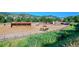 Community horse farm with horses eating in fields under a vibrant blue sky at 18 Blue Sage, Littleton, CO 80127