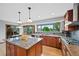 Bright kitchen boasts granite countertops, stainless steel appliances, and large windows with backyard views at 18 Blue Sage, Littleton, CO 80127