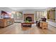 Inviting living room featuring a traditional brick fireplace and hardwood flooring at 18 Blue Sage, Littleton, CO 80127