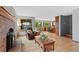 Comfortable living room features a cozy fireplace, wood floors, and views into the kitchen at 18 Blue Sage, Littleton, CO 80127