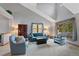 Vaulted living room with neutral tones, plush carpet, and large windows at 18 Blue Sage, Littleton, CO 80127