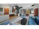 Open-concept living area with access to dining room and staircase at 18 Blue Sage, Littleton, CO 80127