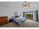 Spacious main bedroom with vaulted ceiling, ceiling fan, and private balcony at 18 Blue Sage, Littleton, CO 80127
