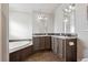 Bathroom boasts a corner tub and double vanity at 4220 Headlight Rd, Strasburg, CO 80136