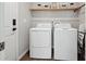 Convenient laundry room with washer, dryer, and overhead shelving at 4220 Headlight Rd, Strasburg, CO 80136