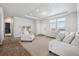 Living room with entryway, two sofas, and plenty of natural light at 4220 Headlight Rd, Strasburg, CO 80136