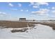 Large lot with outbuildings and snow at 4220 Headlight Rd, Strasburg, CO 80136