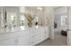 Double vanity bathroom with a modern aesthetic and large mirror at 5193 Carr St, Arvada, CO 80002