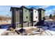 Rear view of townhomes, showcasing garages and ongoing landscape work at 5193 Carr St, Arvada, CO 80002