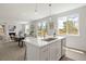 Open concept kitchen with white cabinetry, island, and stainless steel appliances at 5193 Carr St, Arvada, CO 80002