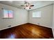 Bedroom boasts beautiful hardwood floors, a ceiling fan, and natural light from two windows at 2027 S Newton St, Denver, CO 80219