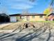 Charming single-story home with a brick facade, front lawn, and attached garage at 2027 S Newton St, Denver, CO 80219