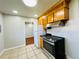 Well-lit kitchen featuring wood cabinets, a stainless steel range, and neutral flooring at 2027 S Newton St, Denver, CO 80219