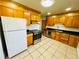 Functional kitchen with classic wood cabinets, and modern stainless steel appliances at 2027 S Newton St, Denver, CO 80219