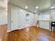 Open living space featuring gleaming hardwood floors and seamless transition to kitchen at 2027 S Newton St, Denver, CO 80219