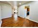 Open-concept living area featuring hardwood floors connecting to kitchen at 2027 S Newton St, Denver, CO 80219