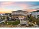 Expansive backyard featuring a cozy fire pit, outdoor seating, and meticulously designed landscaping at 6405 Kenzie Cir, Castle Pines, CO 80108