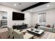 Basement living area with a large TV, comfortable seating, and ample natural light at 6405 Kenzie Cir, Castle Pines, CO 80108