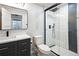 Modern bathroom with a walk-in shower with black trim, stylish vanity, and sleek fixtures at 6405 Kenzie Cir, Castle Pines, CO 80108