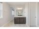 Modern bathroom boasts a vanity with granite countertop, a large mirror, and stylish lighting at 6405 Kenzie Cir, Castle Pines, CO 80108