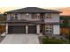 Charming home featuring a two-car garage, stone accents, and well-maintained landscaping at 6405 Kenzie Cir, Castle Pines, CO 80108