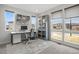 Bright home office featuring a large desk, built-in shelving, and ample natural light from large windows at 6405 Kenzie Cir, Castle Pines, CO 80108