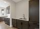 Butler's pantry features custom cabinets, counter space, and a convenient sink at 6405 Kenzie Cir, Castle Pines, CO 80108
