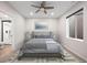 Comfortable main bedroom with a ceiling fan, gray color palette, and an ensuite bathroom with a modern shower at 6405 Kenzie Cir, Castle Pines, CO 80108