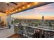 Cozy outdoor patio with a built-in bar, string lights, and incredible sunset views at 6405 Kenzie Cir, Castle Pines, CO 80108