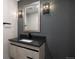 Stylish powder room with gray wall paint, decorative lighting fixtures, and a modern vanity with a vessel sink at 6405 Kenzie Cir, Castle Pines, CO 80108