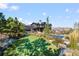 Expansive backyard with a putting green, lush landscaping, and a luxury pool at 7868 Cicero Ct, Littleton, CO 80125