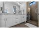 Spacious bathroom with double sinks, a glass walk-in shower, and white cabinetry at 7868 Cicero Ct, Littleton, CO 80125