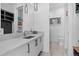 Bright bathroom featuring a modern sink and vanity, wall mirror, and pendant lighting at 7868 Cicero Ct, Littleton, CO 80125