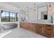 Stunning bathroom featuring double sink vanity with elegant light fixtures and a soaking tub with a view at 7868 Cicero Ct, Littleton, CO 80125