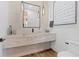 Modern bathroom featuring a floating sink, stylish mirror, and contemporary light fixture at 7868 Cicero Ct, Littleton, CO 80125