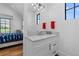 Well-lit bathroom with white cabinets, modern fixtures and a large window at 7868 Cicero Ct, Littleton, CO 80125