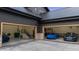 Spacious three-car garage featuring epoxy floors and ample storage space at 7868 Cicero Ct, Littleton, CO 80125