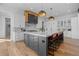 A modern kitchen with a marble countertop island with seating and stainless steel appliances at 7868 Cicero Ct, Littleton, CO 80125