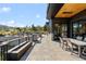 Lovely outdoor patio with a dining area, a fire feature, and views of the pool and backyard at 7868 Cicero Ct, Littleton, CO 80125