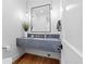 Modern powder room with a floating vanity and stylish fixtures, offering a touch of elegance at 7868 Cicero Ct, Littleton, CO 80125