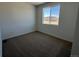 Cozy bedroom with plush carpet and a window offering natural light and neighborhood views at 6648 N Nepal Ct, Aurora, CO 80019