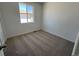 Comfortable carpeted bedroom with natural light streaming in through a window at 6648 N Nepal Ct, Aurora, CO 80019
