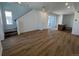 Bright living space with hardwood floors, a staircase, and a sliding glass door at 6648 N Nepal Ct, Aurora, CO 80019