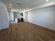 Open-concept living room featuring hard wood floors with an adjacent kitchen, perfect for entertaining at 6648 N Nepal Ct, Aurora, CO 80019