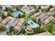 Aerial view of a well-maintained community with tennis courts, pool, and lush landscaping at 7355 S Knolls Way, Centennial, CO 80122