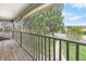 Covered balcony overlooking the yard with views of the green grass and mature trees at 7355 S Knolls Way, Centennial, CO 80122
